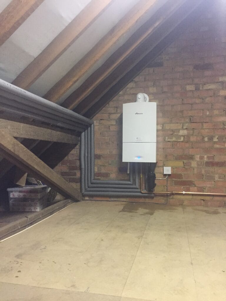 Wall-mounted gas boiler in a plant room with multiple heating circuits
