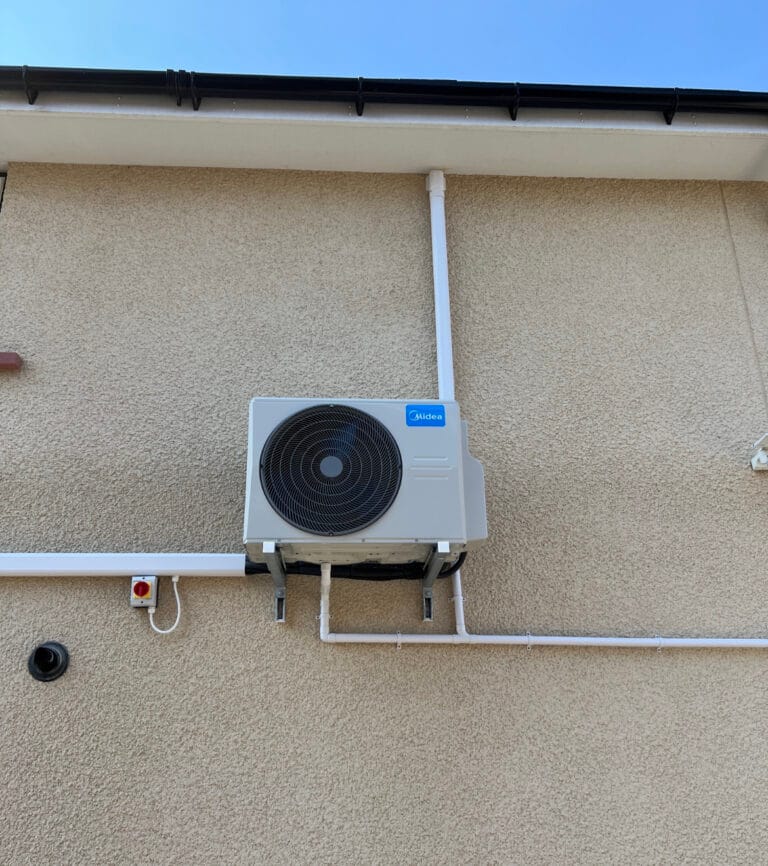 Midea outdoor air conditioning condenser mounted securely on wall brackets