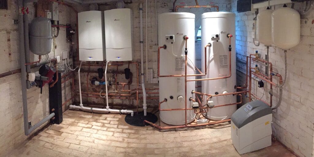 Twin Worcester Bosch boilers and twin hot water cylinders installed by Oxyplumb in a large plant room