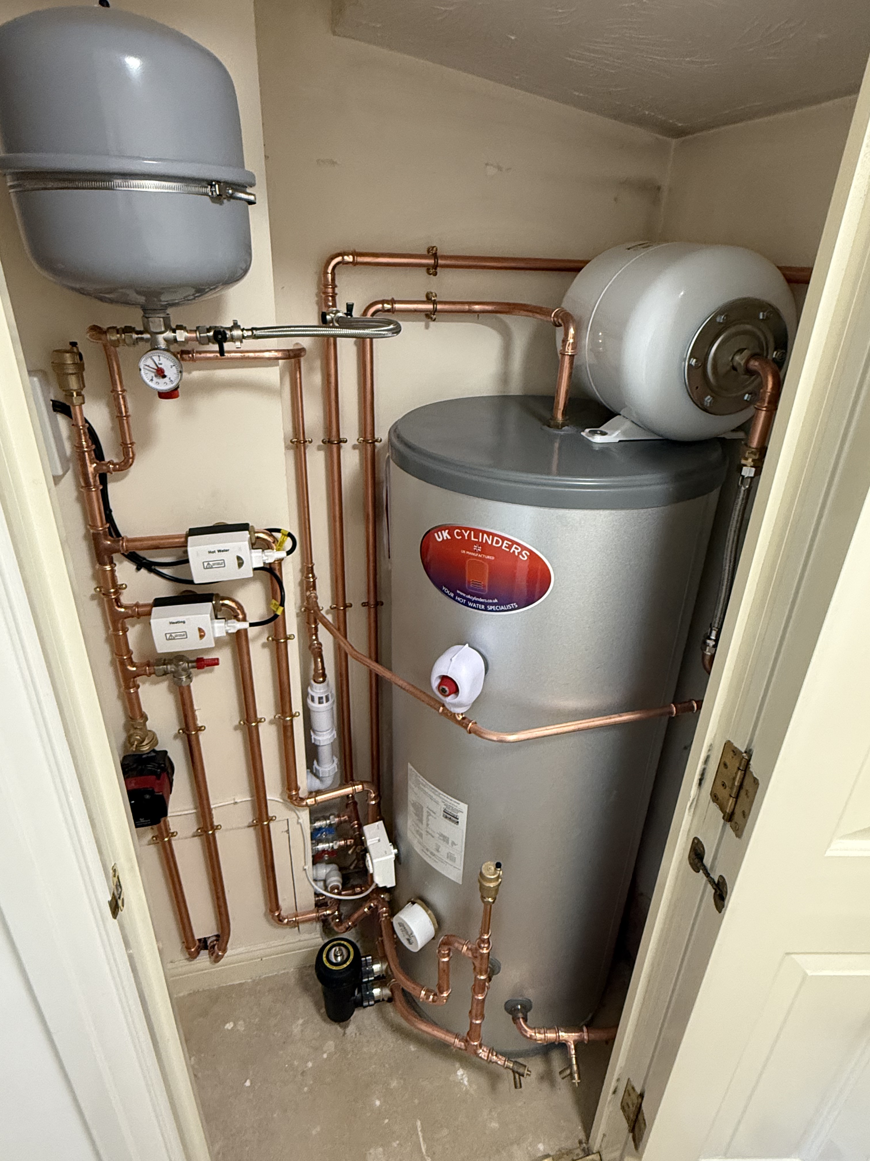 Unvented hot water cylinder installed in a cupboard by Oxyplumb in Oxfordshire