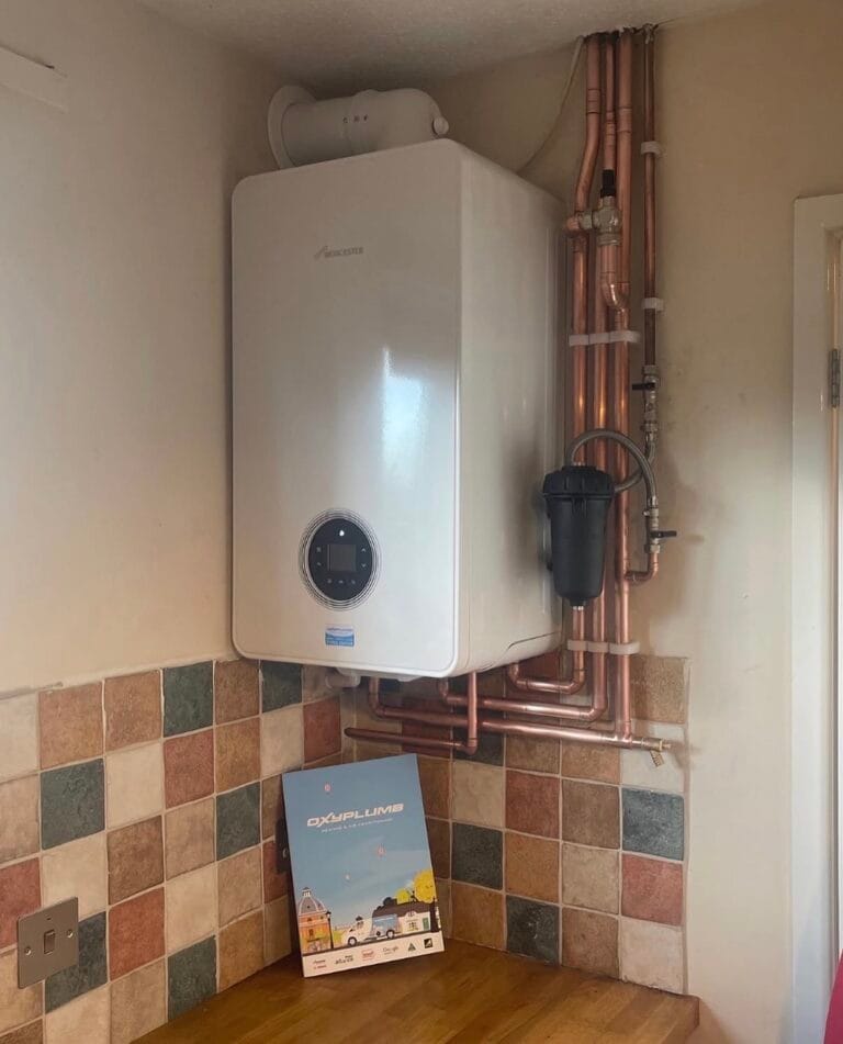 Worcester Bosch boiler installed above a kitchen worktop with copper pipework